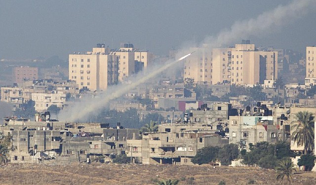 A rocket launched by Palestinian militants flies toward Israel on Thursday from the northern Gaza Strip. Israel said militants fired about 450 rockets since the start of the Israeli offensive Wednesday and said its missile-defense system has intercepted about 130 of those rockets. 