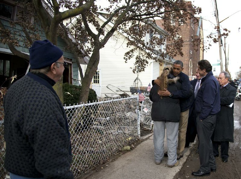 President Barack Obama, accompanied by New York City Mayor Michael Bloomberg, New York Gov. Andrew Cuomo and U.S. Sen. Charles Schumer, D-N.Y., hugs Debbie Ingenito on Thursday on Cedar Grove Avenue, a Staten Island street significantly affected by superstorm Sandy. 