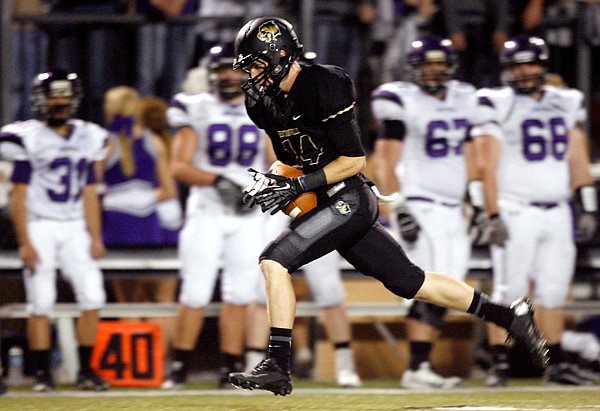 Trey Perkins, Bentonville senior wide receiver, pulls in a long reception for a touchdown Nov. 2 against Fayetteville at Tiger Stadium in Bentonville. 