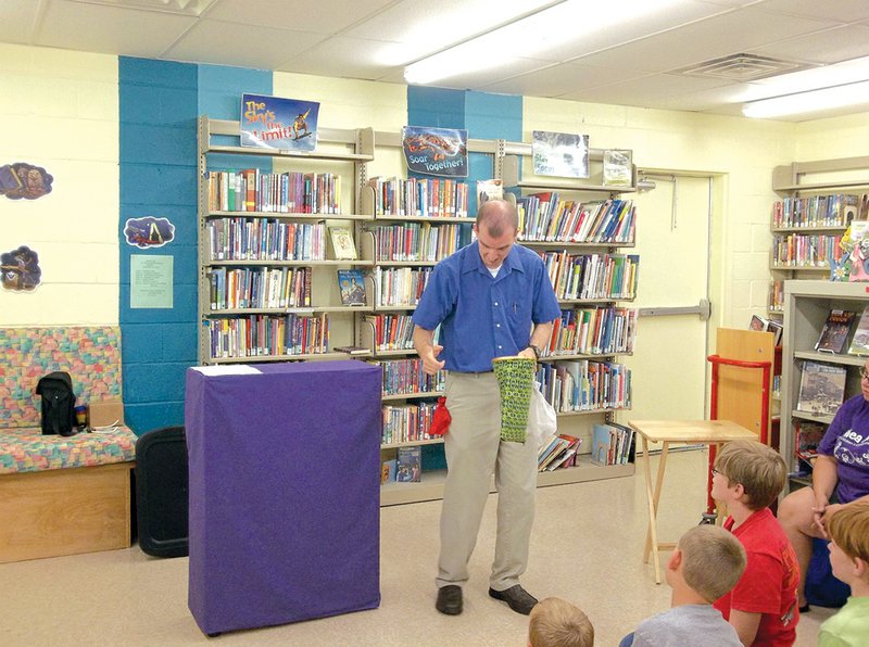 Magician Steven Blythe performs a show for children at the Pangburn Library. The children’s portion of the library has been open for a year.