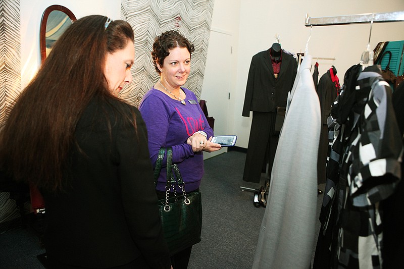 Kathleen Travis-Neal, left, and Sarah Torres look at clothes that are available in the Dress Up boutique. Women In Networking and Goodwill partnered to offer the boutique, which provides business attire to women looking for a job.