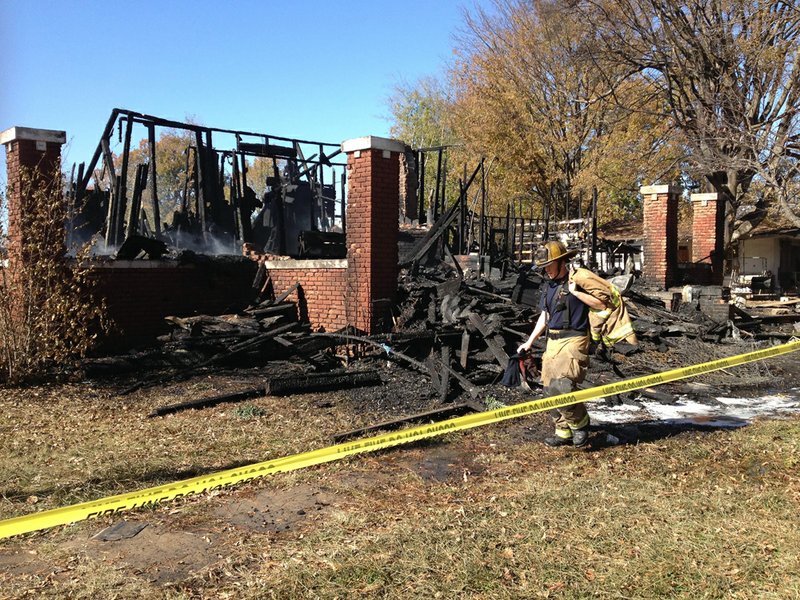 Fire officials work at Fifth and Poplar streets in Pine Bluff.