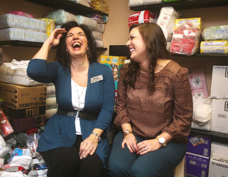 Dorcas VanGilst (left) and Michelle Dewitt share a laugh in the Dorcas House supply room, full of the diapers, cleaning products and paper towels the house always needs. VanGilst is director of the house’s domestic violence program and Dewitt heads up the substance abuse program. 