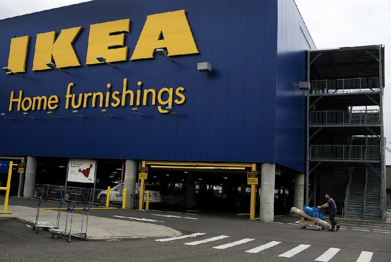 A customer moves his purchases outside the Ikea store in Brooklyn, N.Y., in September. The com2pany said it regrets that some of its products were made using East German prison labor decades ago. 