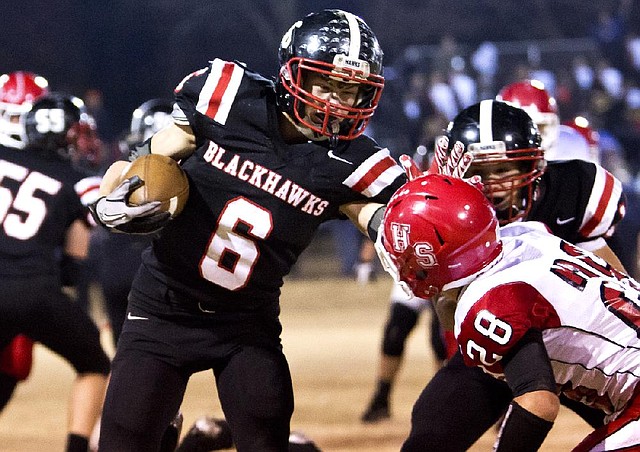 Pea Ridge running back Dayton Winn stiff-arms Heber Springs’ Morgan Brooks on Friday night in Pea Ridge. Heber Springs defeated the Blackhawks 42-21 and will play at Highland in the quarterfinals. 