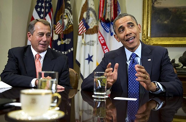 House Speaker John Boehner (left) looks on as President Barack Obama speaks to reporters Friday at the White House before a meeting with congressional leaders on a framework for averting the “fiscal cliff.” 