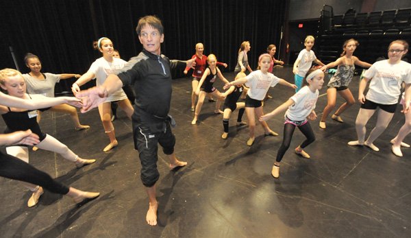 Choreographer and dancer Bill Hastings, left, leads a group of students Oct. 14 through a series of dance moves while hosting a workshop, through assistance from Dance and More Store, for area students to benefit the Thea Foundation at the Walton Arts Center in Fayetteville. The arts center board is planning to open another center in Bentonville and is considering locations. 