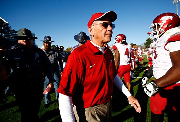 NWA Media/JASON IVESTER -- Arkansas head coach John L. Smith leaves the field following the Razorbacks' 45-14 loss to Mississippi State on Saturday, Nov. 17, 2012, at Davis Wade Stadium in Starkville, Miss.