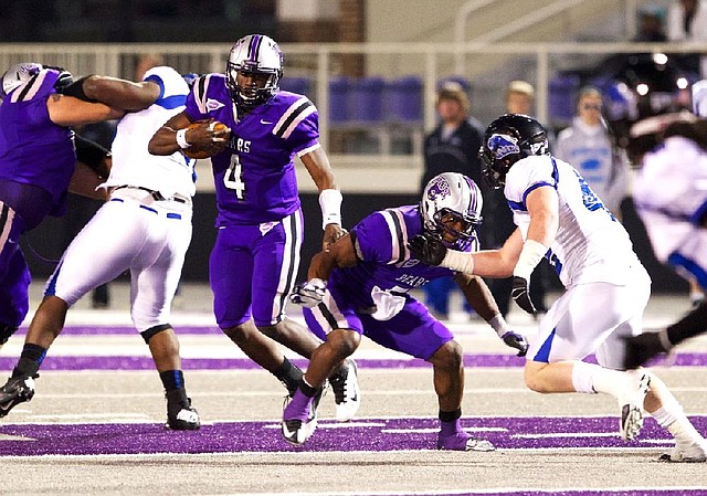 Central Arkansas quarterback Wynrick Smothers (4) runs behind running back Jackie Hinton as he scrambles to avoid the Eastern Illinois defense during the first half Saturday at Estes Stadium in Conway. Smothers completed 35 of 49 passes for 335 yards and 4 touchdowns and the Bears won 48-30. 