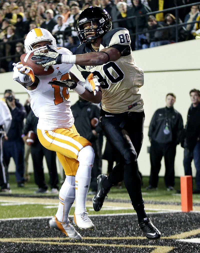 Vanderbilt wide receiver Chris Boyd (80) catches an 11-yard touchdown pass in front of Tennessee defensive back Marsalis Teague (10) during the second quarter of the Commodores’ 41-18 victory over the Volunteers on Saturday in Nashville, Tenn. 