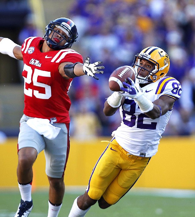 LSU wide receiver James Wright (82) pulls in a 48-yard reception in front of Mississippi defensive back Cody Prewitt (25) during the first half of the No. 7 Tigers’ 41-35 victory over the Rebels on Saturday in Baton Rouge. 