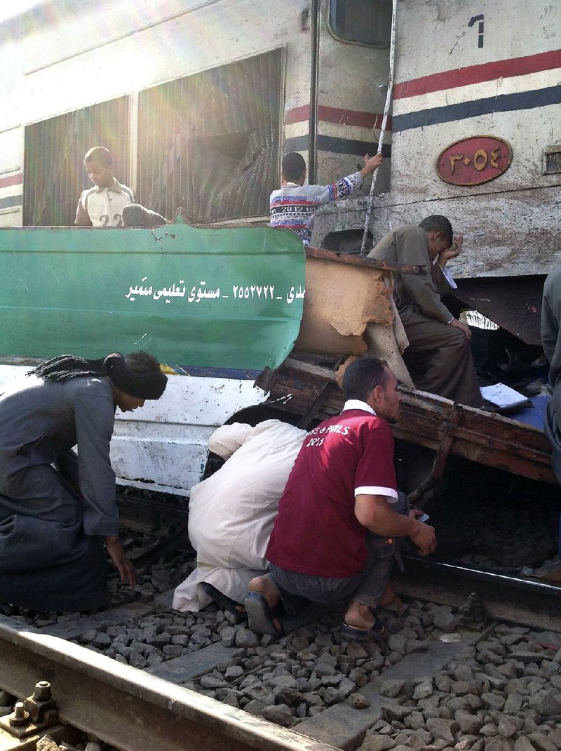 Distraught Egyptians search for loved ones Saturday in the wreckage of a train that crashed into a bus carrying children to a kindergarten near Assiut, Egypt. At least 50 people, most of them children, were killed.