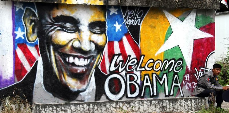 A police officer Saturday in Rangoon, Burma, guards a mural created by Burmese graffiti artists welcoming President Barack Obama. 