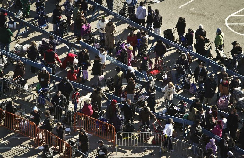 Hundreds of people affected by storm Sandy wait in line Saturday in Brooklyn, N.Y., for items distributed by the Federal Emergency Management Agency. 