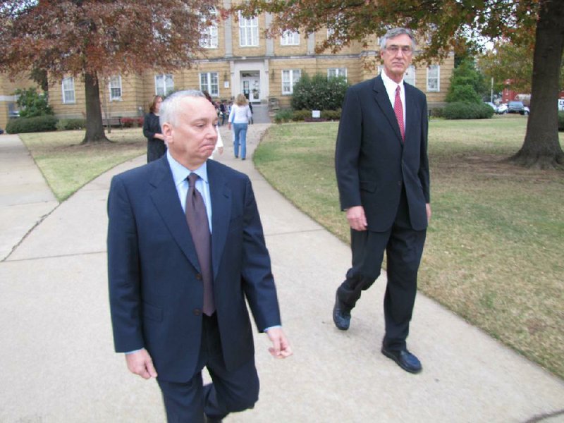 Former University of Central Arkansas Chief of Staff Jack Gillean (left) leaves the Faulkner County Courthouse on Monday with attorney Sam Perroni after pleading innocent to four felony charges and a misdemeanor. 