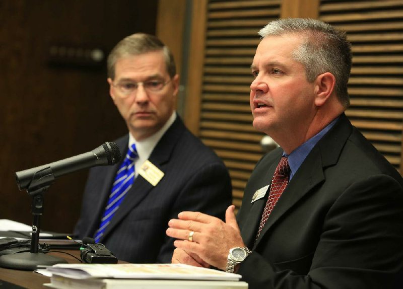 Tom Kimbrell (right), state education commissioner, comments on the 2012 school accountability report Monday in Little Rock. 