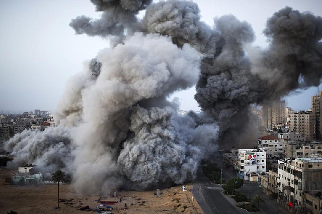 Smoke rises after an Israeli strike in Gaza on Sunday. The Israeli military widened its range of targets in the Gaza Strip to include the media operations of the Palestinian territory’s Hamas rulers, sending its aircraft to attack two buildings used by both Hamas and foreign media outlets. 