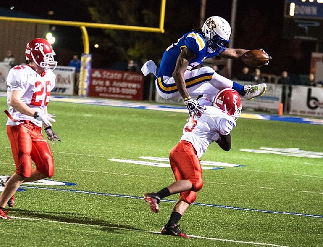 North Little Rock running back Altee Tenpenny jumps over Cabot defensive back Jordan Burke during the Charging Wildcats’ 28-0 victory in the Class 7A quarterfinals Friday night in North Little Rock. Tenpenny, who rushed for 141 yards in Friday’s victory, was penalized on the play for hurdling. The Charging Wildcats will begin their first season without Tenpenny tonight after Tenpenny graduated and signed with Alabama.