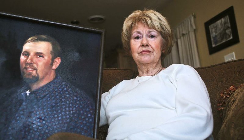 Fran Marshall, president of the Arkansas Chapter of American Gold Star Mothers Inc., a private nonprofit organization of women who have lost a child due to war, poses with a photograph of her son, Bradley, who died in Tunis, Iraq, in 2007 at age 37 of wounds he sustained from enemy mortar fire. 