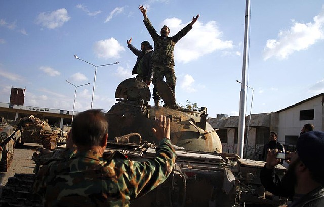 Syrian rebels celebrate Monday after their weekend takeover of a government base outside Aleppo. 