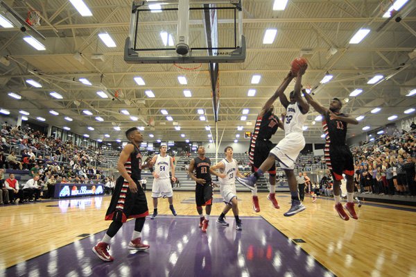 Fayetteville’s Manuale Watkins attempts a shot against Fort Smith Northside defenders Tuesday. 