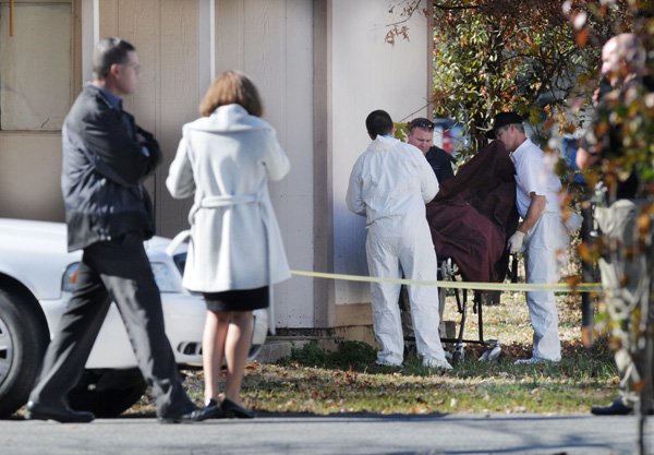 Benton County Coroner’s office employees prepare to remove the body of a 6-year-old girl Tuesday near her home. Police found the body during a search after the girl was reported missing Tuesday morning. 