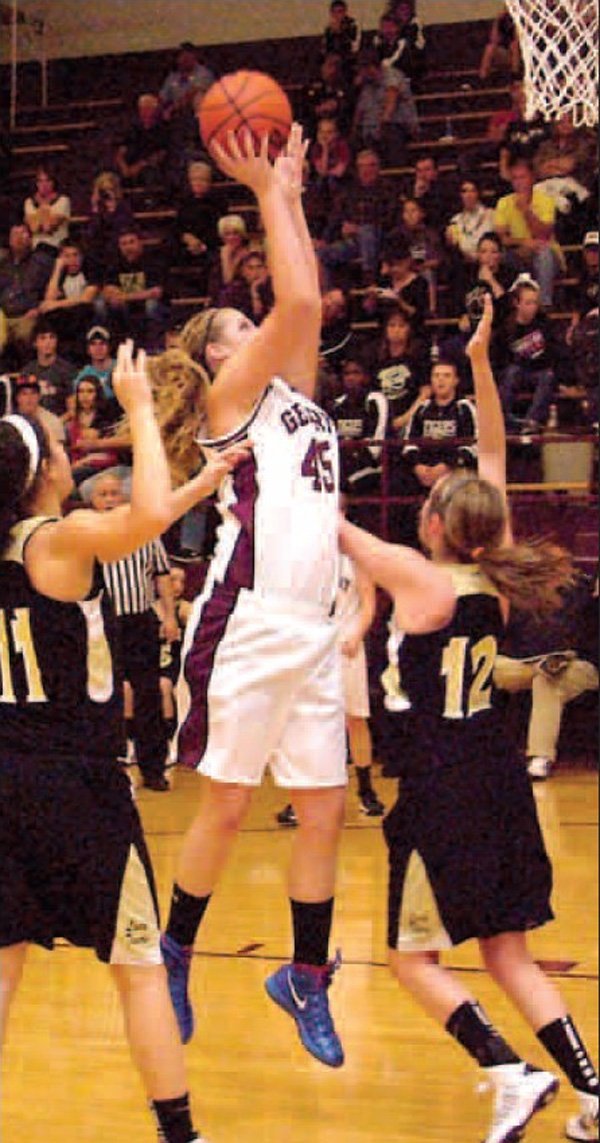 Surrounded by West Fork defenders, Gentry’s center, Heather Marshall, puts in a quick jump shot for two in an earlier home game. Marshall helps the Lady Pioneers dominate under the basket. 