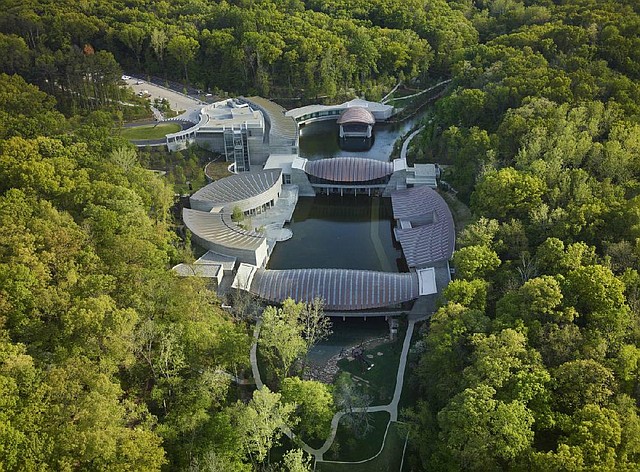 Designed by Moshe Safdie, the multiple buildings of Crystal Bridges Museum nestle seamlessly into the Ozark landscape.