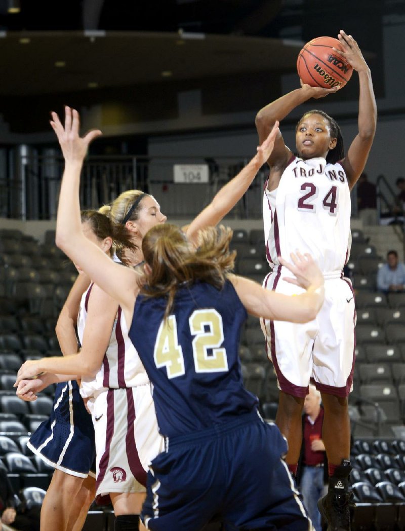 UALR guard Taylor Gault (middle) tries to drive to the basket between two Tulsa defenders during the Trojans’ 78-51 victory Tuesday at the Jack Stephens Center in Little Rock. 