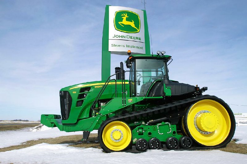 A John Deere tractor is parked at the Stevens Implement Company in Petersburg, Ill., in this file photo. The company reported a quarterly profit of $687.6 million on Wednesday. 