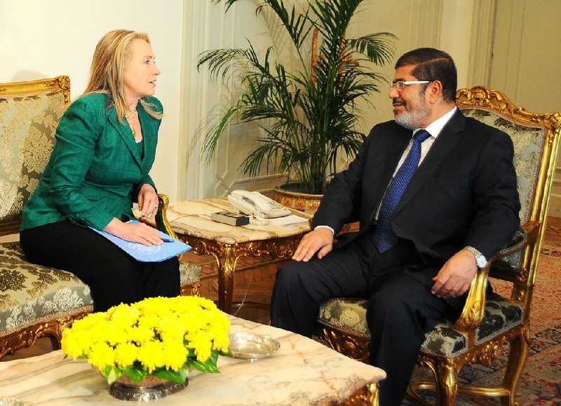 Egyptian President Mohammed Morsi talks Wednesday with Secretary of State Hillary Rodham Clinton in Cairo in this photo released by Morsi’s office. 