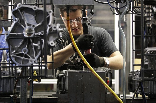 Jesus Serna works at Generac Power Systems Inc., one of the largest makers of residential generators in the U.S., in Whitewater, Wis., last week. The number of first-time applications for unemployment benefits fell last week, and a measure of economic indicators rose in October, led by a demand for large manufactured goods. 