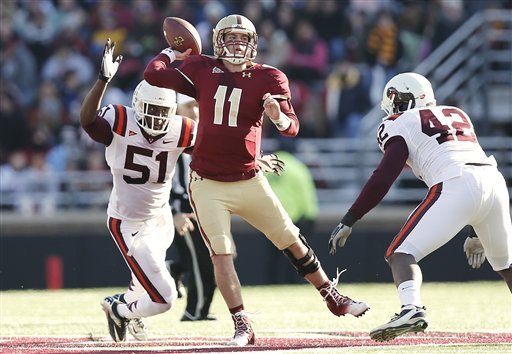 Boston College quarterback Chase Rettig throws under pressure from Virginia Tech's Bruce Taylor (51) and J.R. Collins during the first half of a NCAA football game at Alumni Stadium in Boston Saturday.