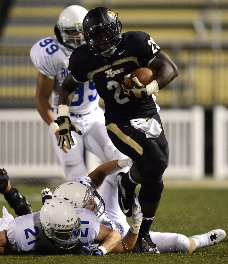 Bentonville running back Tearris Wallace (29) has rushed for 4,453 yards for the top-ranked Tigers, who have won 35 consecutive regular-season games. 