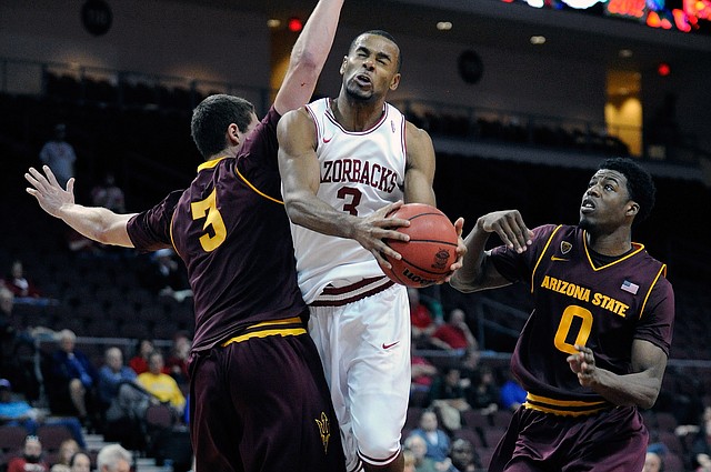 Arkansas' Rickey Scott (3) drives to the basket between Arizona State's Eric Jacobsen (3) and Carrick Felix (0) during the second half of an NCAA college basketball game at the Continental Tire Las Vegas Invitational tournament on Friday, Nov. 23, 2012, in Las Vegas. Arizona State won 83-68. (AP Photo/David Becker)