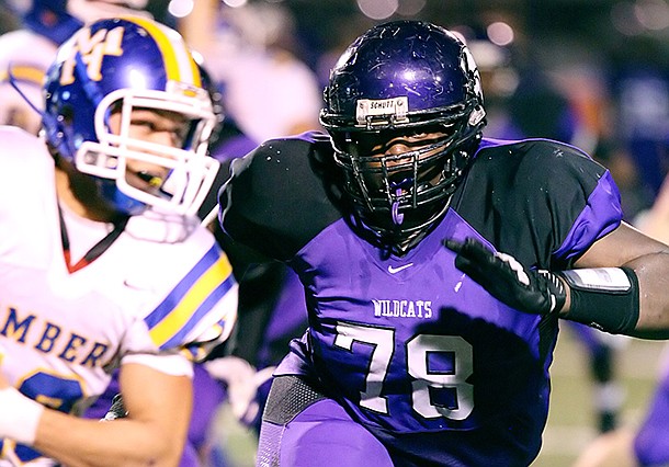 El Dorado News-Times/Michael Orrell -- El Dorado's Bijhon Jackson tracks Mountian Home's Andrew Stolpe in the first round of the 6A state playoffs at Memorial Stadium in El Dorado on Friday, Nov. 9, 2012. 