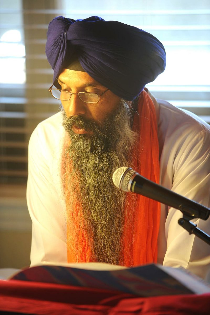 Jaswinder Singh Sandhu reads from the 1,430-page Sikh holy book, the Sri Guru Granth Sahib. Sandhu and other local Sikhs were gathered to celebrate the birthday of the religion’s founder, Guru Nanak Dev Ji. 
