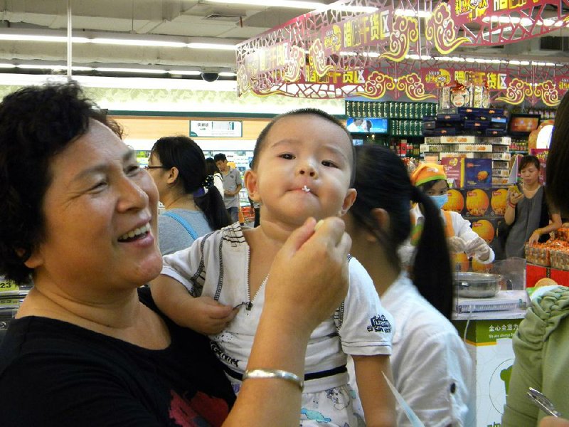 A child samples U.S.-grown rice during a marketing study in September at a store in Guangzhou, China. The U.S. rice industry has spent more than six years trying to win permission to export their crops to the world’s largest rice producer. 