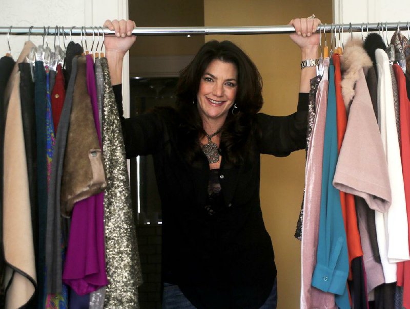 Lila Ashmore, Festival of Fashion chairman, looks through a rack of clothes from a local boutique. She changed the annual event from a seated luncheon to a runway show with 10 local stores showing clothing and accessories. 