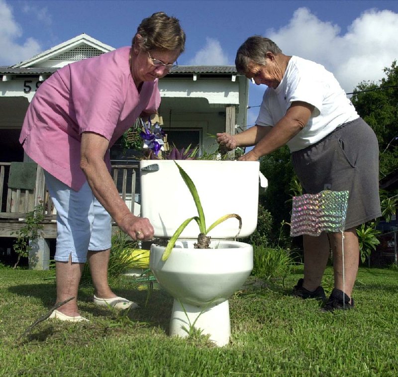 Mary Frances and Ralph Cotter tend their commode farm south of Scott. The Cotters provide a loving retirement home for old toilets that have outlived their primary purpose. 