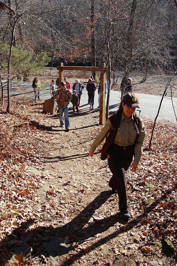 Rebekah Penny, an interpreter at Devil’s Den State Park in southern Washington County, leads a hike Friday along Yellow Rock Trail. The park promoted the day as Green Friday, an alternative to Black Friday, the busiest shopping day of the year. 