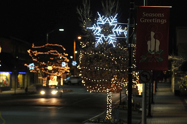 Christmas decorations hang Friday from poles along Emma Avenue in Springdale. The city changed out many light bulbs to LED lights in the hopes of brighter lights that last longer and use less energy. 