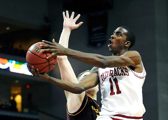Arkansas' BJ Young (11) drives to the basket with Arizona State's Jonathan Gilling defending during the second half of the Sun Devils’ 83-68 victory Friday night over the Razorbacks. 
