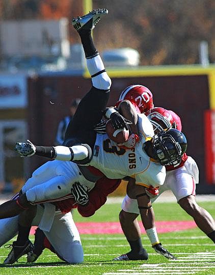 Henderson State linebacker Maxie Graham (hidden) throws down Missouri Western State wide receiver Tyron Crockom during the second half of Saturday’s NCAA Division II playoff game at Carpenter-Haygood Stadium in Arkadelphia. Missouri Western won 45-21. More photos available online at arkansasonline.com/galleries. 