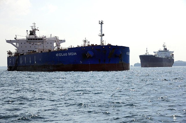 Finaval SpA’s Neverland Dream oil tanker (left) is seen in Singapore, Asia’s largest oil-trading-and-storage center. Customs data show Iranian oil shipments to Asia have increased since the West tightened sanctions in July. 