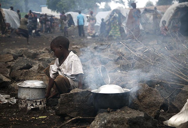 A Congolese child displaced by fighting heats water Saturday at the Mugunga refugee camp on the outskirts of Goma. 