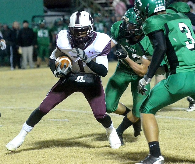 Prescott running back Lavarious Martin (1) tries to get away from Greenland defender Kayden Dennis near the goal line during the first half of Friday’s game in Greenland. Prescott won 49-14. 
