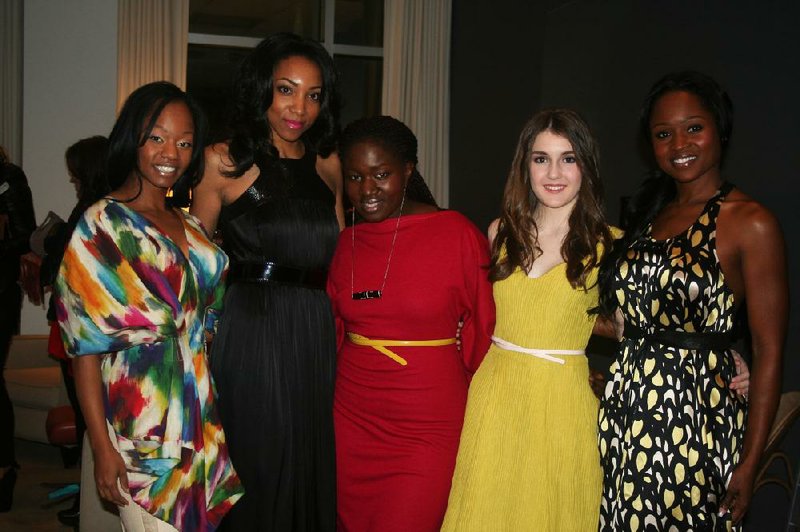 Korto Momolu (center) poses with models who are wearing creations from her spring 2013 collection. 