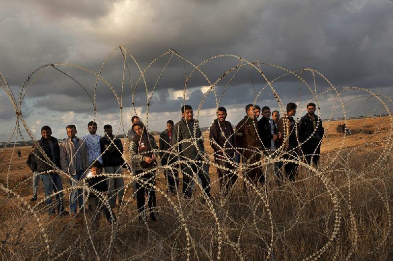 Palestinians gather Friday along the Israeli-Gaza border fence east of Khan Younis in southern Gaza Strip.


