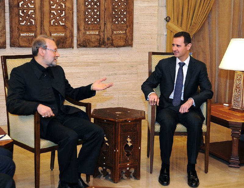 Syrian President Bashar Assad (right) meets Friday in Damascus with the speaker of the Iranian parliament, Ali Larijani.